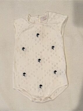 White Knit Baby One-Piece with Navy Motifs